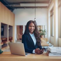 African businesswoman smiling at desk 299130290